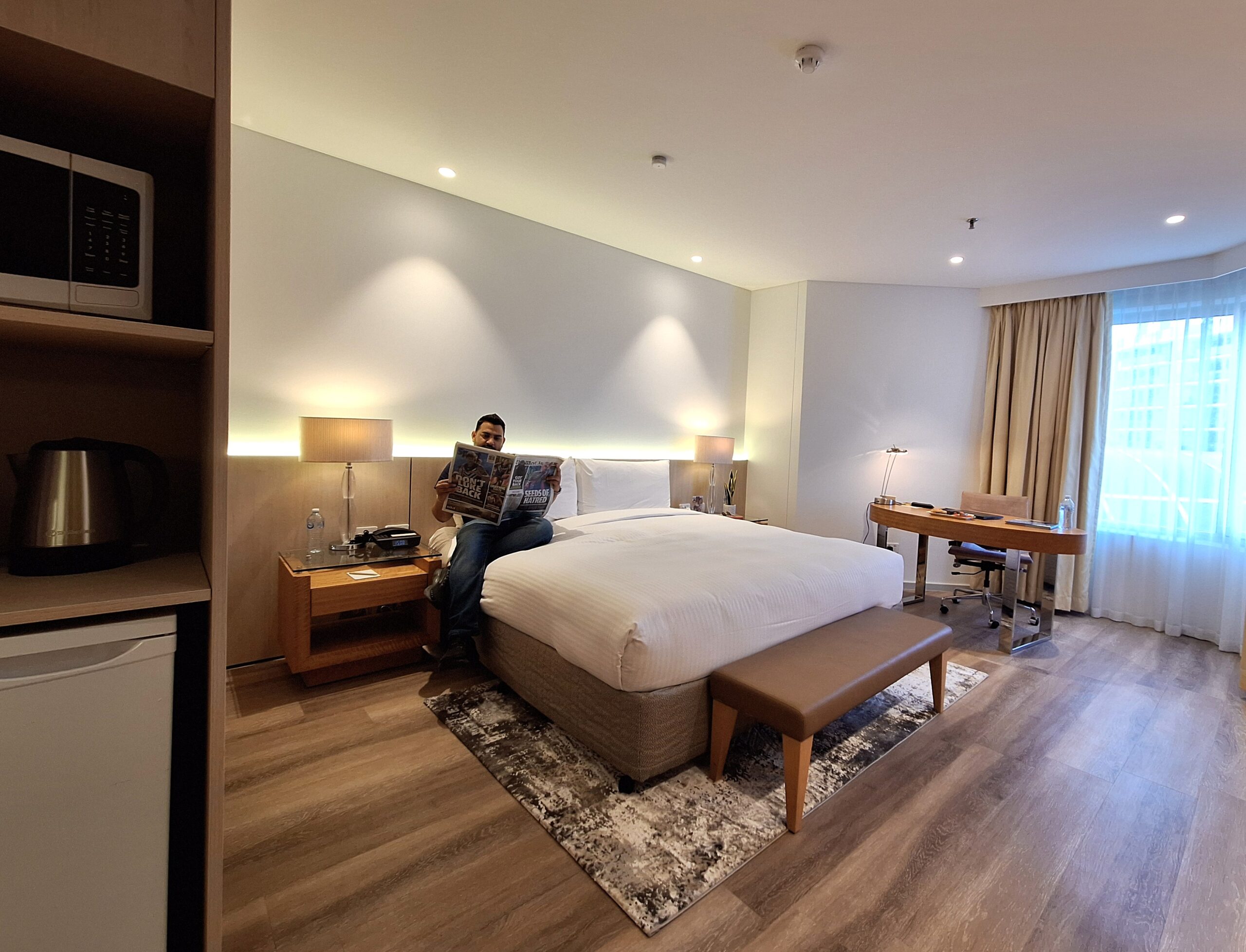 guest of a hotel reading a news paper