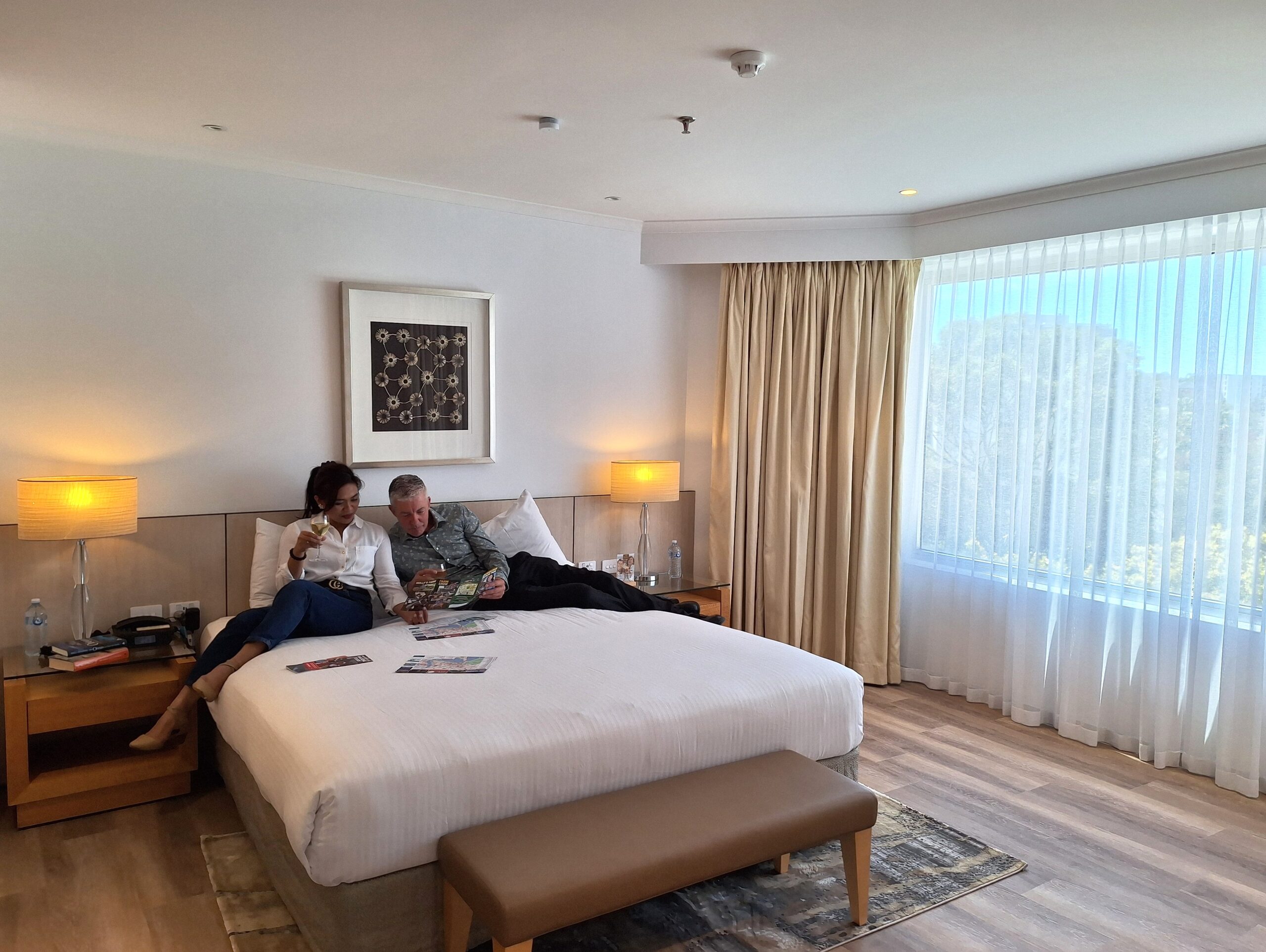 Couple relaxing on hotel bed