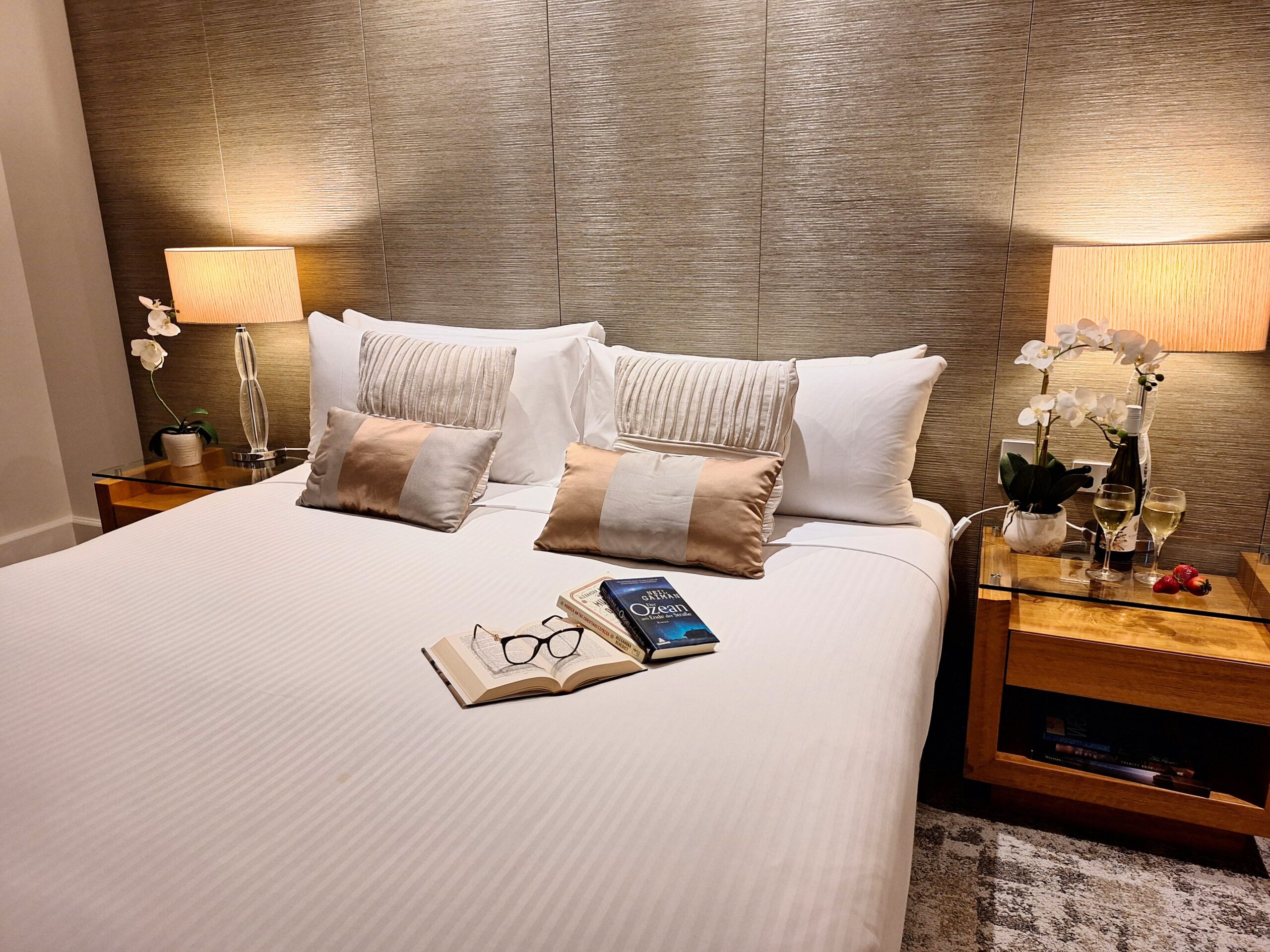 Glasses and a book on the bed