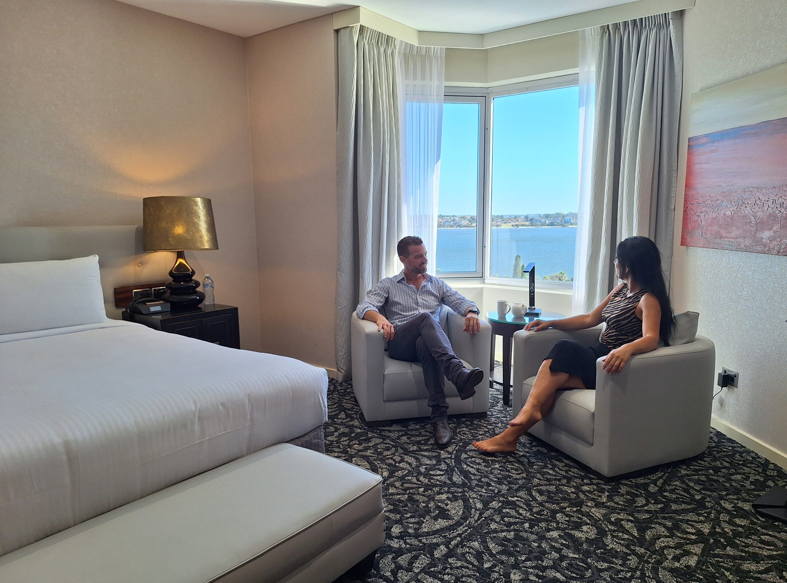 Couple enjoying waterfront view in room