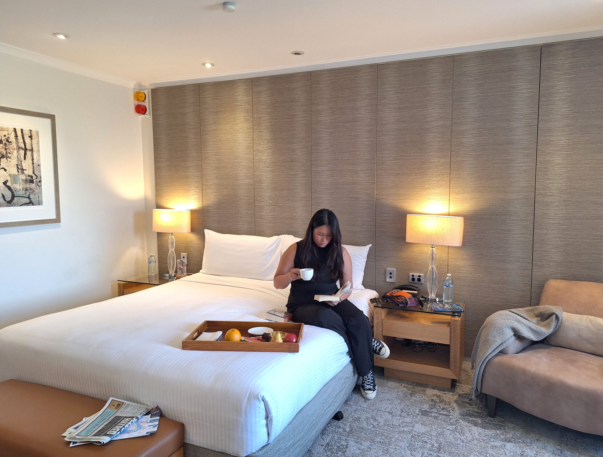 hotel room with reading guest