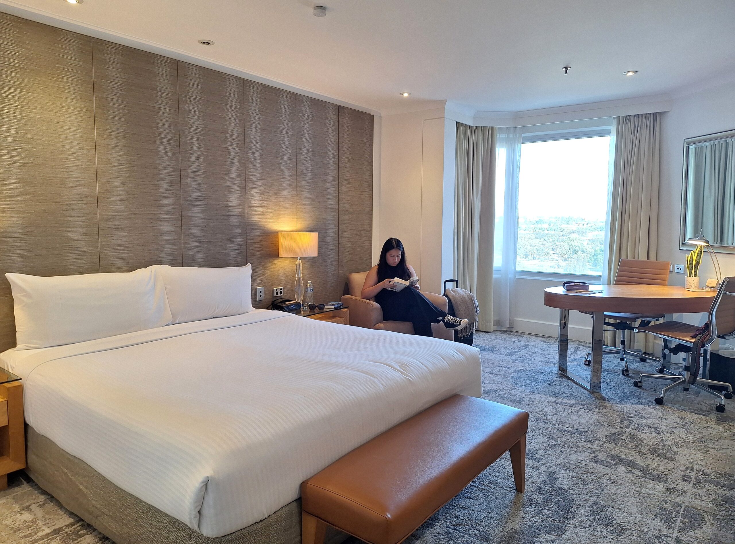 a hotel room with a person reading